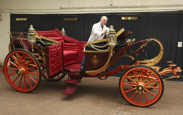 Carriage restorer Dave Evans cleans the 1902 State Landau coach at the Royal Mews in London. Weather permitting, the coach will be used to carry Britain's Prince William and Kate Middleton on their wedding day, April 29.